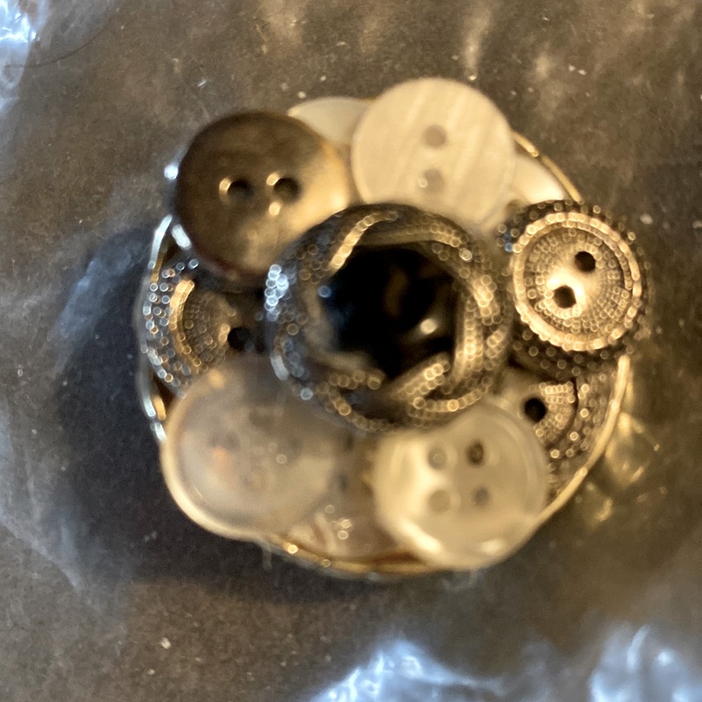 Very interesting button broach/pin. Very different. And interesting.